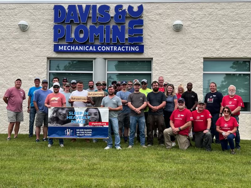 Davis & Plomin employees and volunteers at a Sleep in Heavenly Peace bed build outside the Contract Street shop