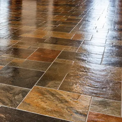 Grout brush scrubbing dirty grout