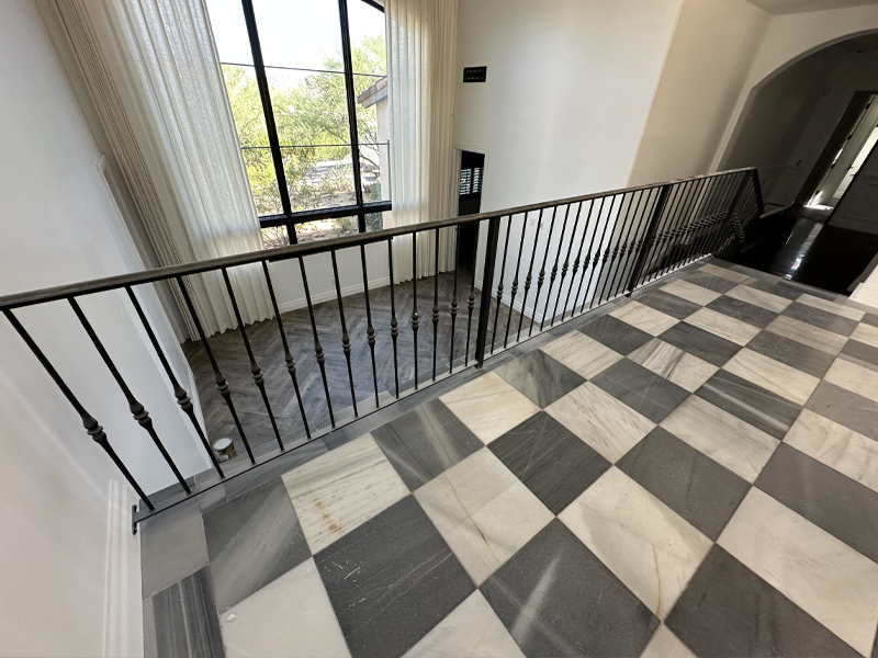 Black-and-white checkerboard marble flooring before restoration in Paradise Valley
