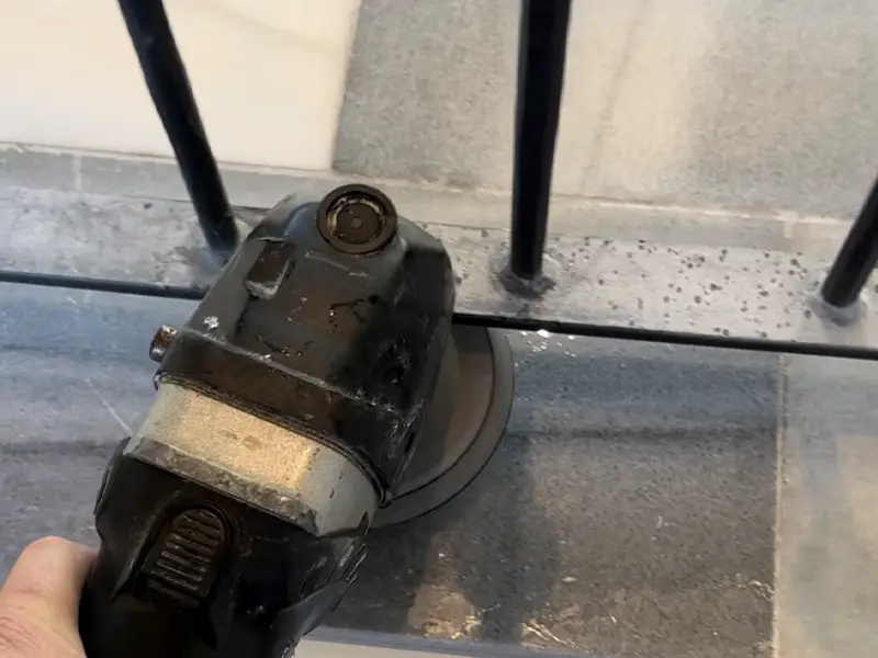 Marble floor near stair railing requiring detailed hand polishing