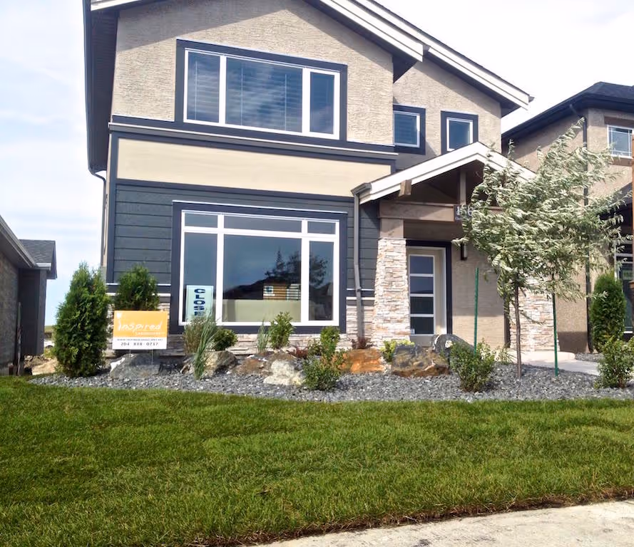 Finished Winnipeg landscape with defined lawn and planting beds