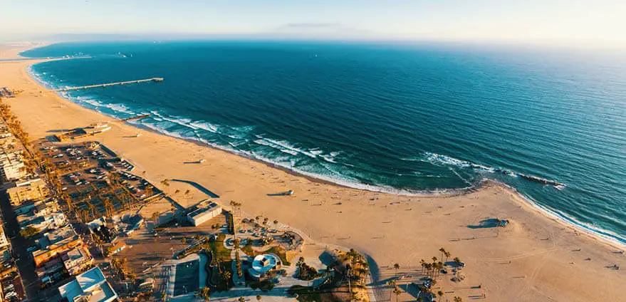 Aerial view of the shoreline in Venice Beach, CA on a bright summer day.