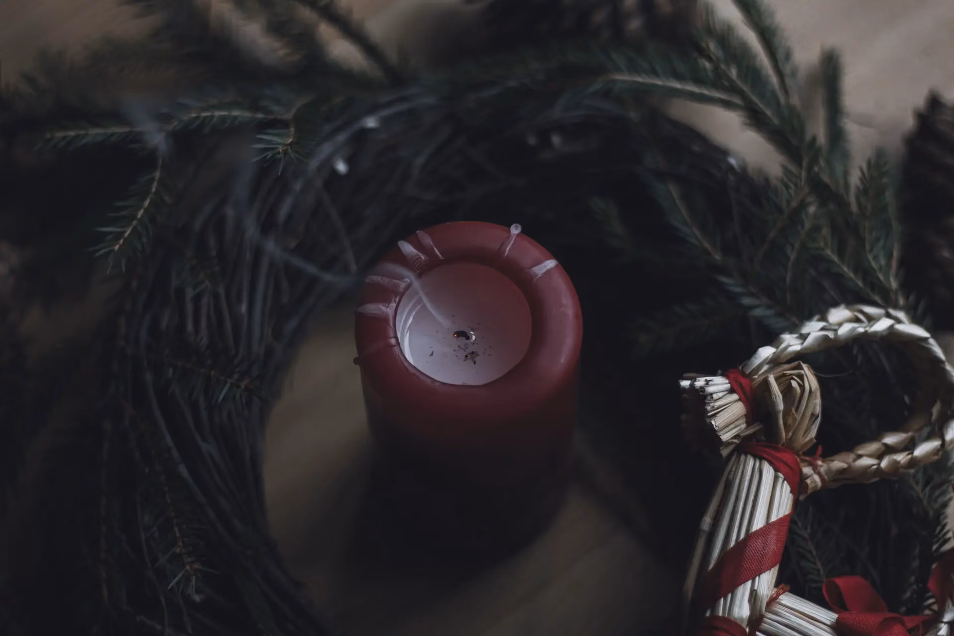 red yule candle in a wreath