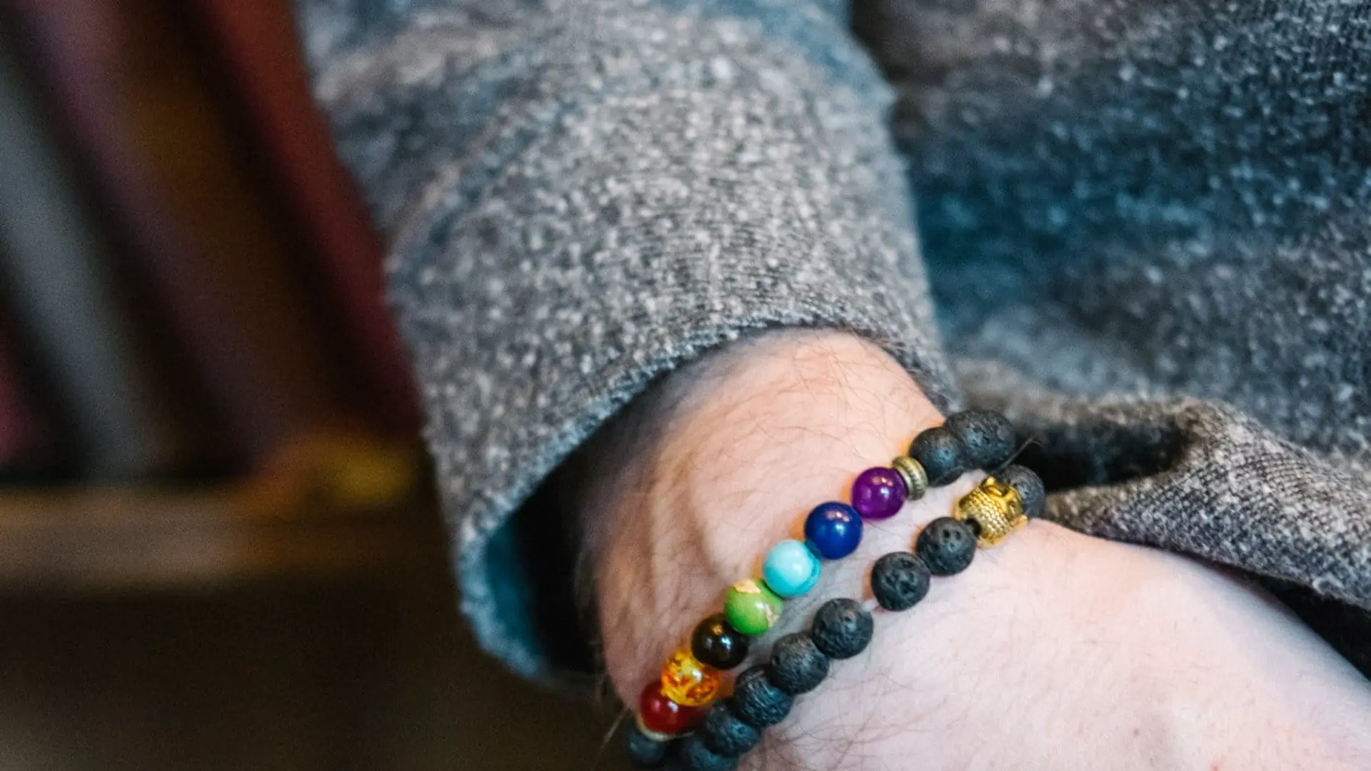 person wearing a chakra bracelet