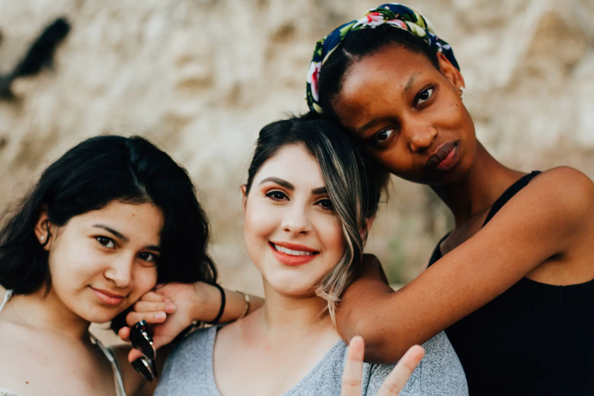 three women pose together
