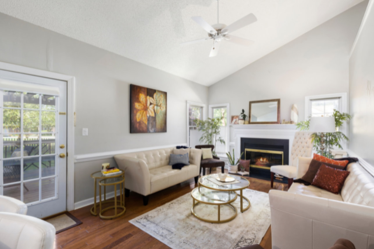 A cozy living room featuring a fireplace, two comfortable couches, and warm lighting for a welcoming atmosphere. 