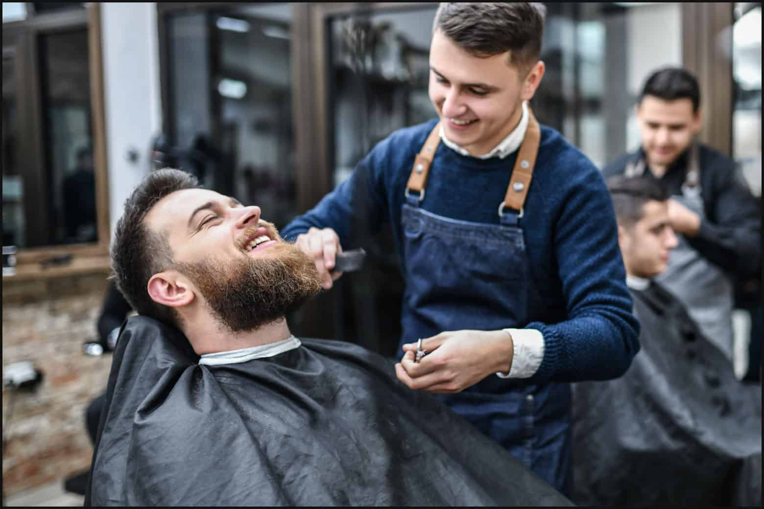 barber cutting hair and beard
