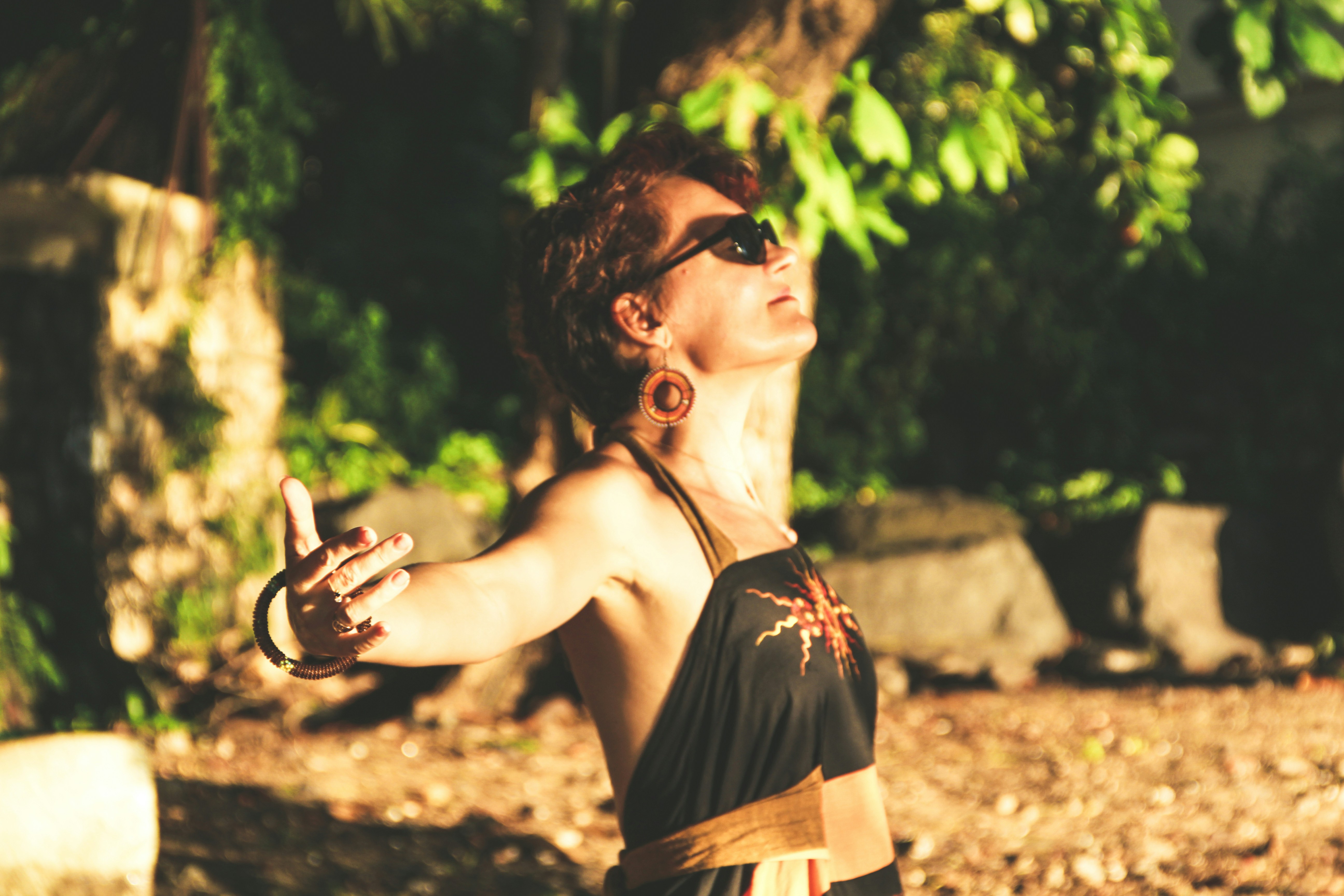 A woman in a black top standing in the sun