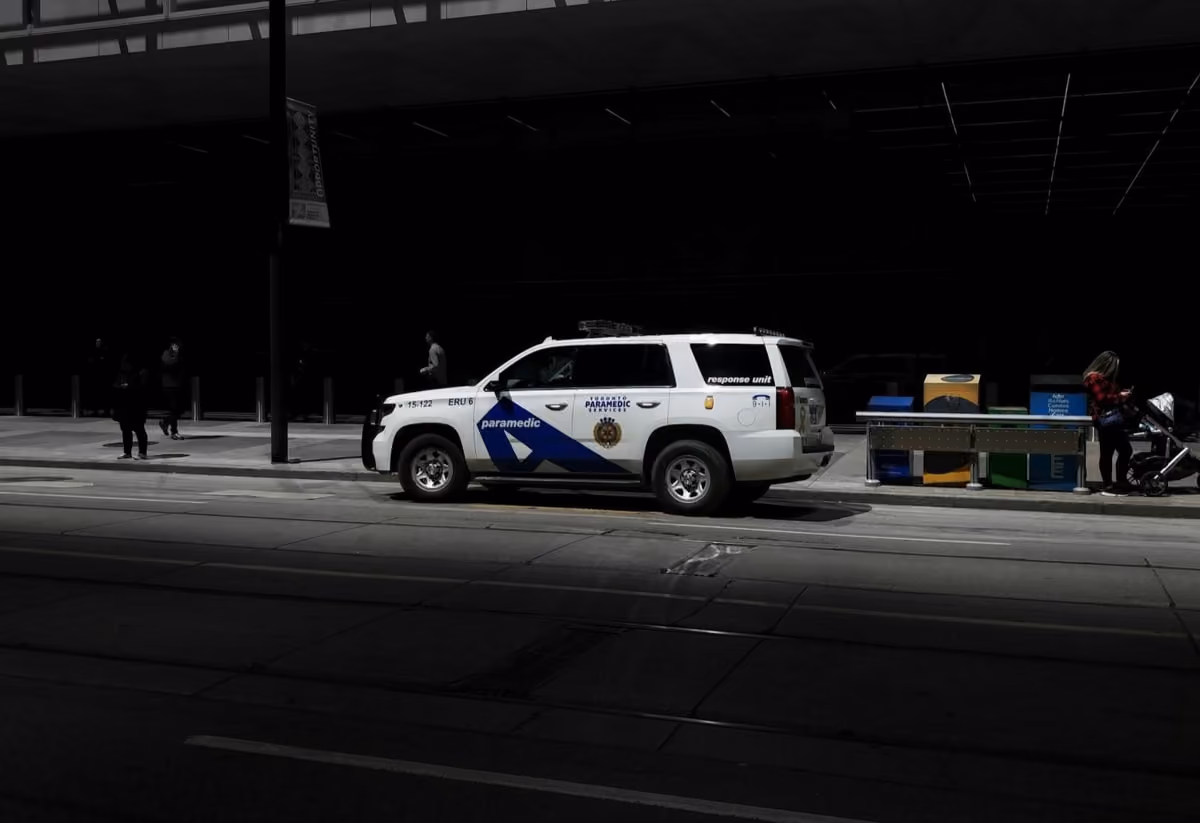 A police car parked in front of a building, indicating a law enforcement presence in the area.