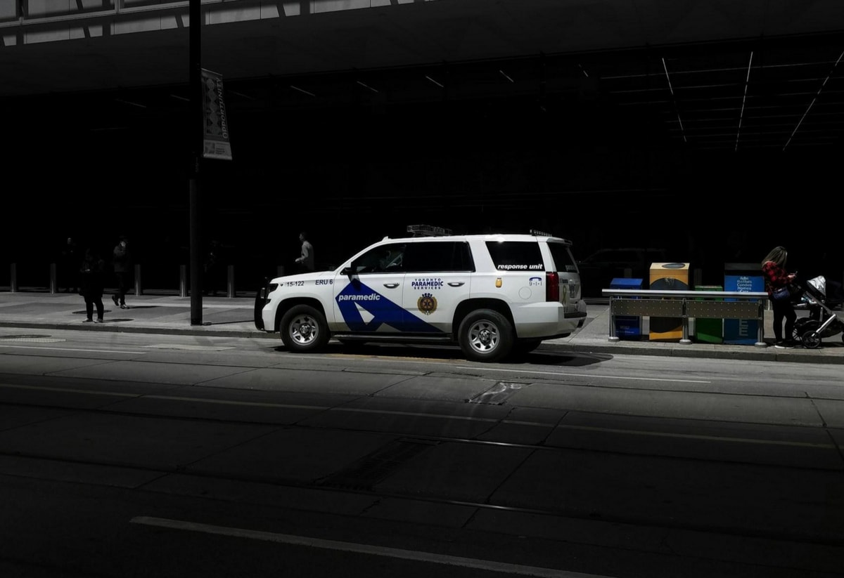 A police car parked in front of a building, indicating a law enforcement presence in the area.