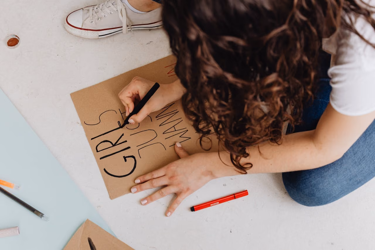 Woman creating a cardboard sign