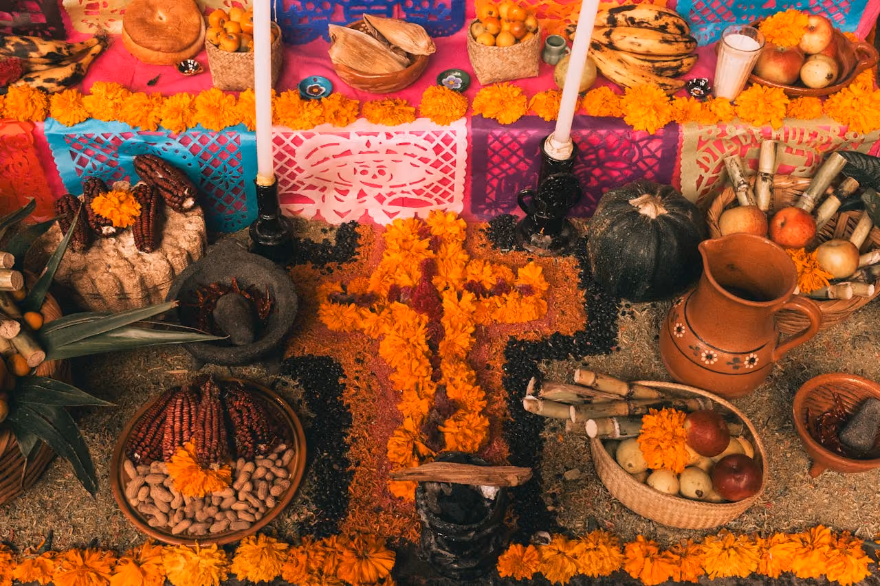 an ofrenda laid with candles and food during Dios de Los Muertos, a celebration derived from Samhain on The Wheel of the Year