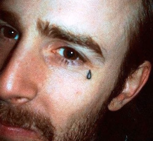 man with a single teardrop tattoo under his eye