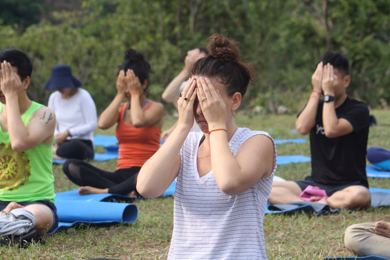 group learning to practice self reiki with a hands over the eyes hand positioning