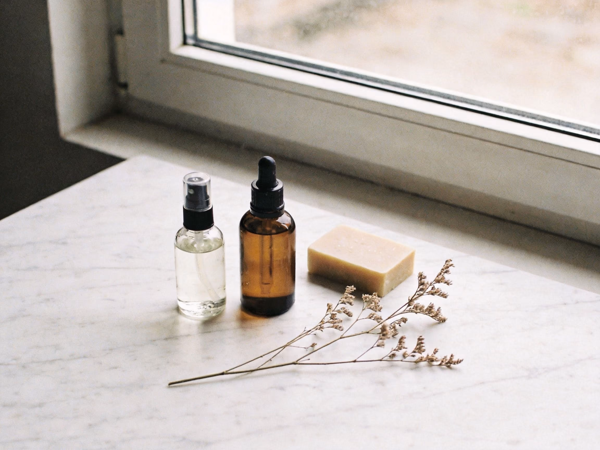 Clean beauty products arranged on a marble surface — representing the growing movement toward non-toxic, transparent personal care formulations.