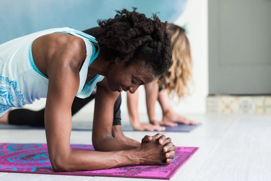 two women doing yoga together