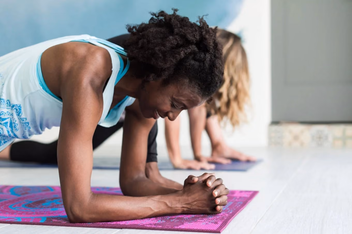 two women doing yoga together