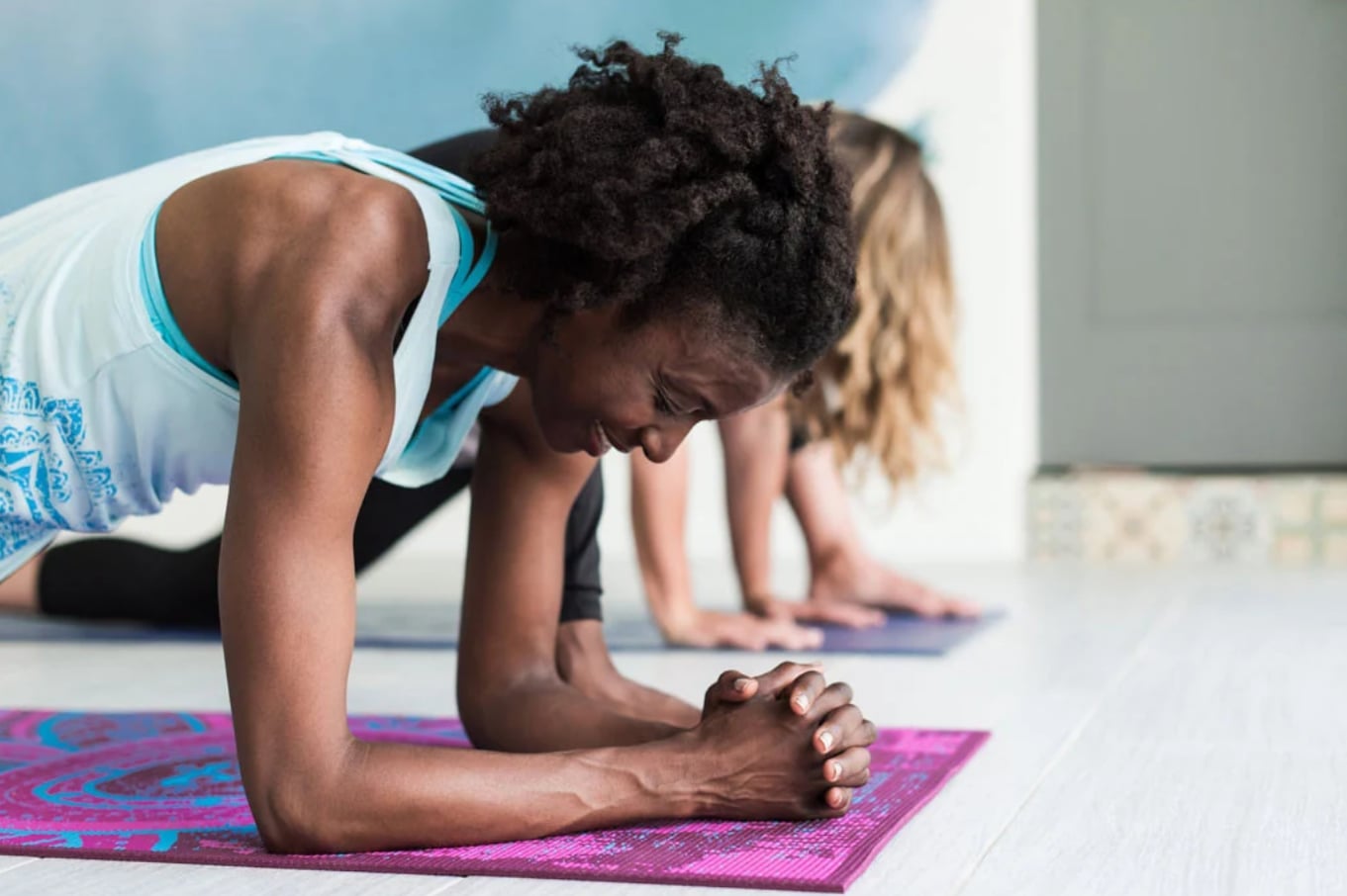 two women doing yoga together