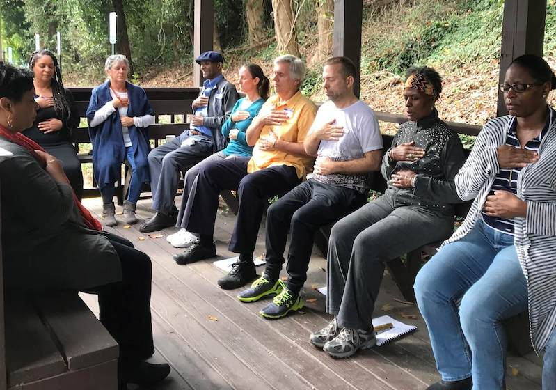 people seated together doing self reiki