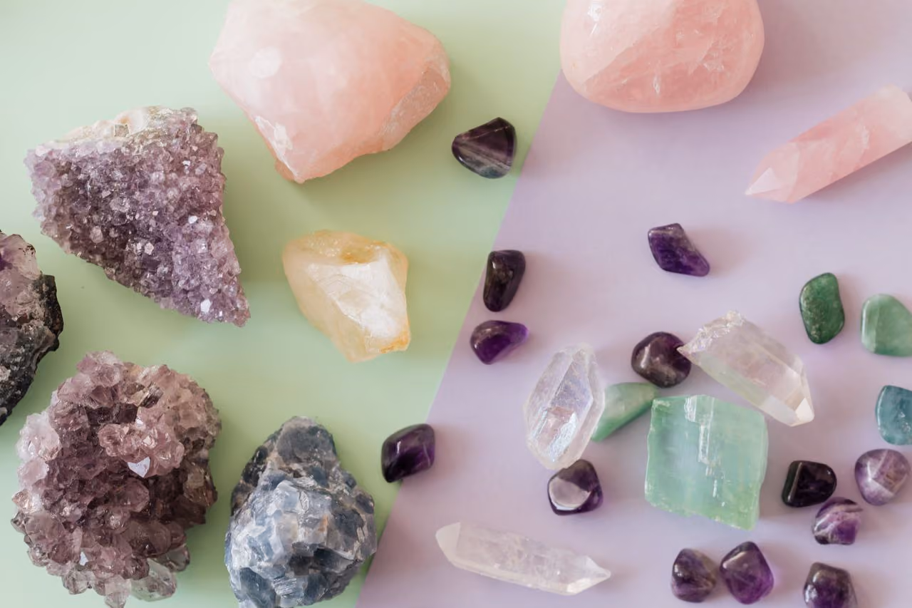 Amethyst cluster and tumbled specimens showing deep purple color — representing the stone of calm, spiritual protection, and third eye activation used in meditation and spiritual practice.