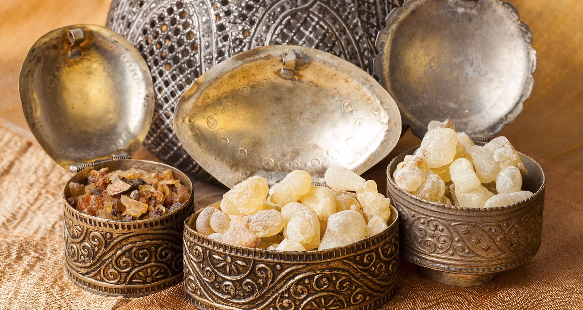 decorative metal containers opened to reveal frankincense and myrrh