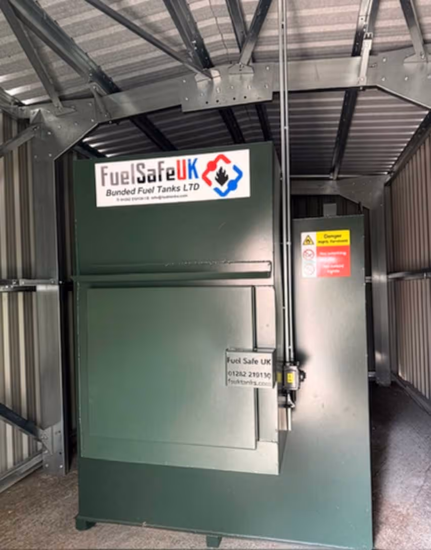 Green industrial fuel tank unit inside a metal shed, labeled with Fuel Safe UK.