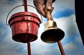 Salvation Army bell ringer and bucket