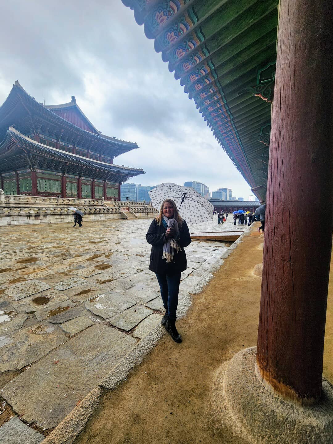 A woman enjoying the beautiful rainy weather covered herself with an umbrella due to rain at Gyeongbokgung Palace in Seoul.