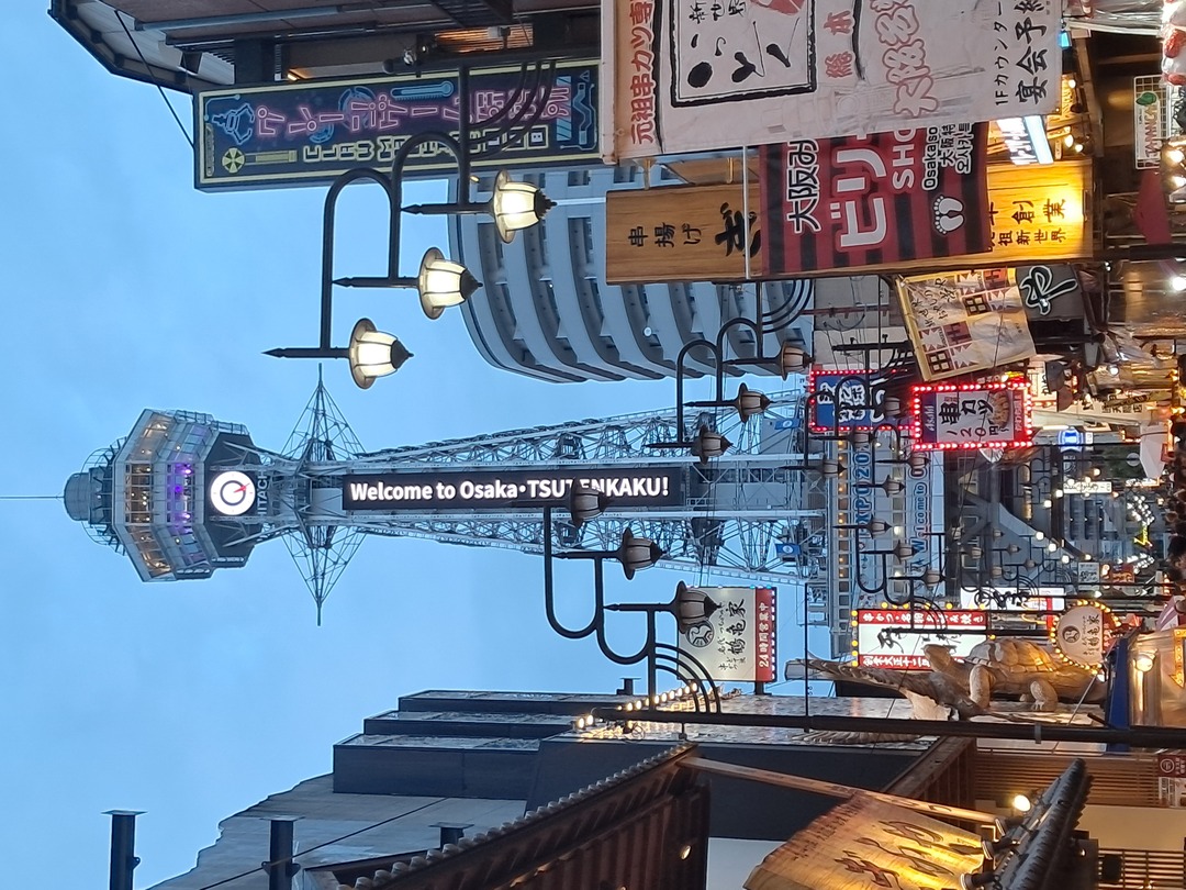 A lively city street filled with colorful neon lights and various signs, showcasing the vibrant nightlife.