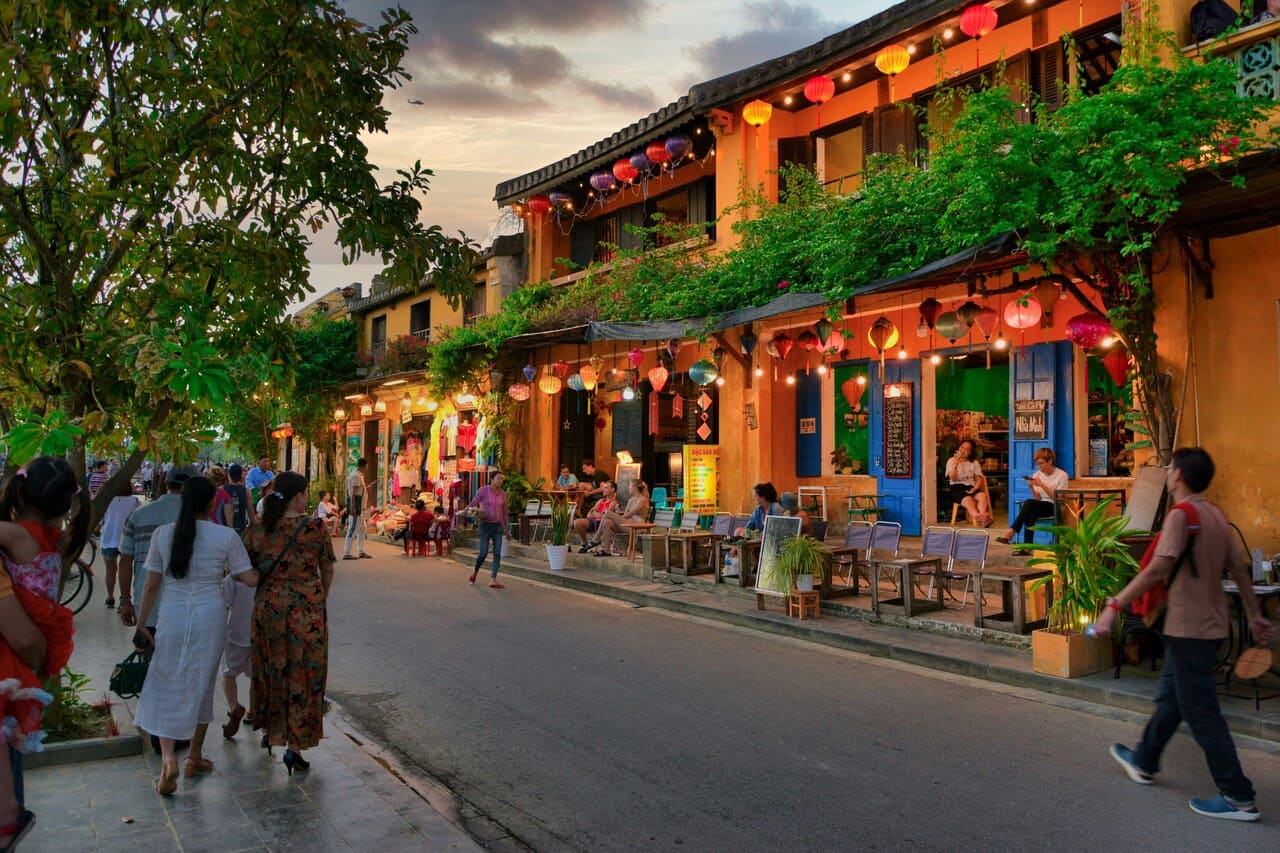 Colorful lanterns illuminating Hoi An Ancient Town at sunset in Vietnam.