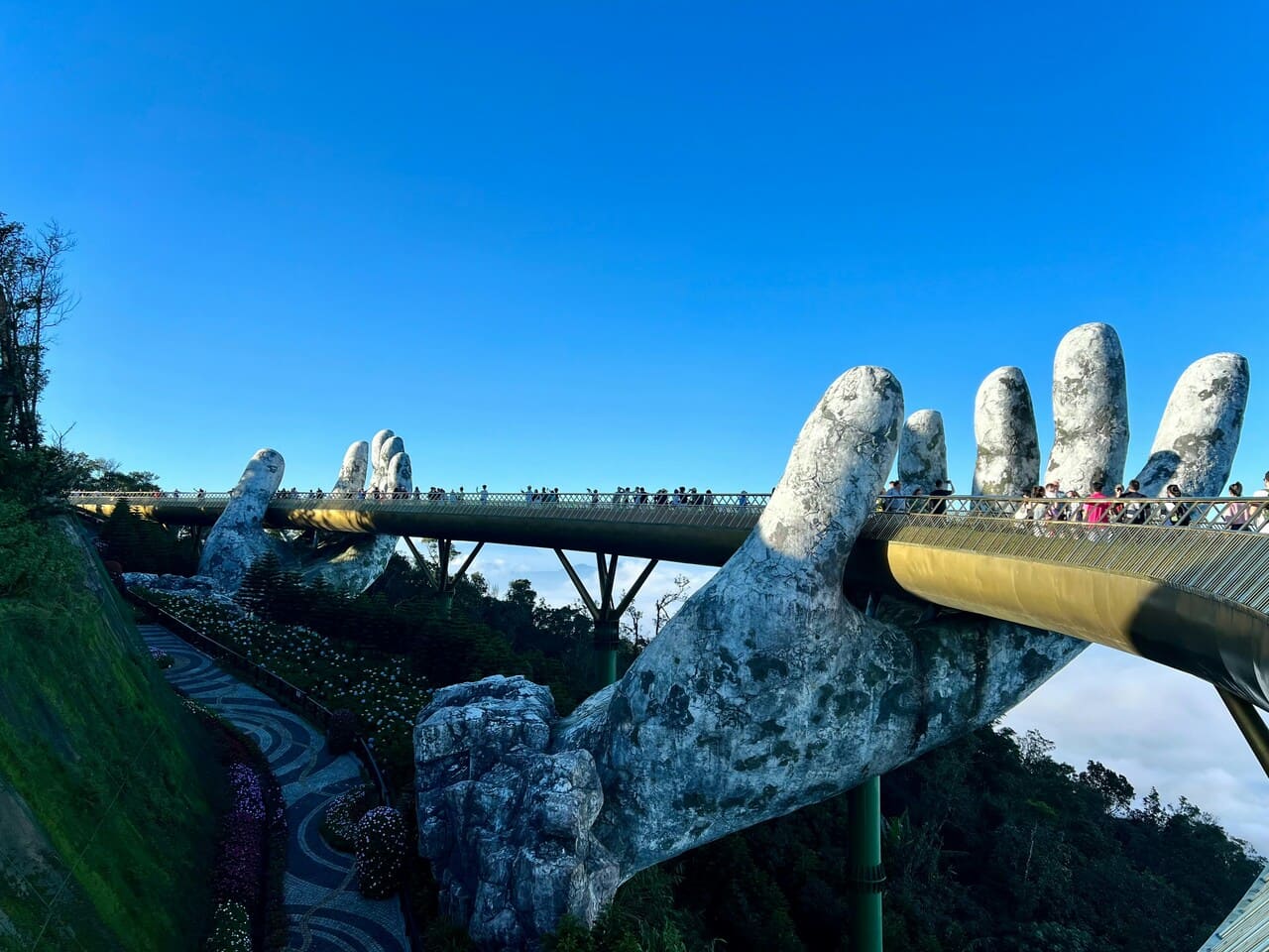 Golden Bridge in Ba Na Hills near Da Nang, Vietnam, supported by giant stone hands.