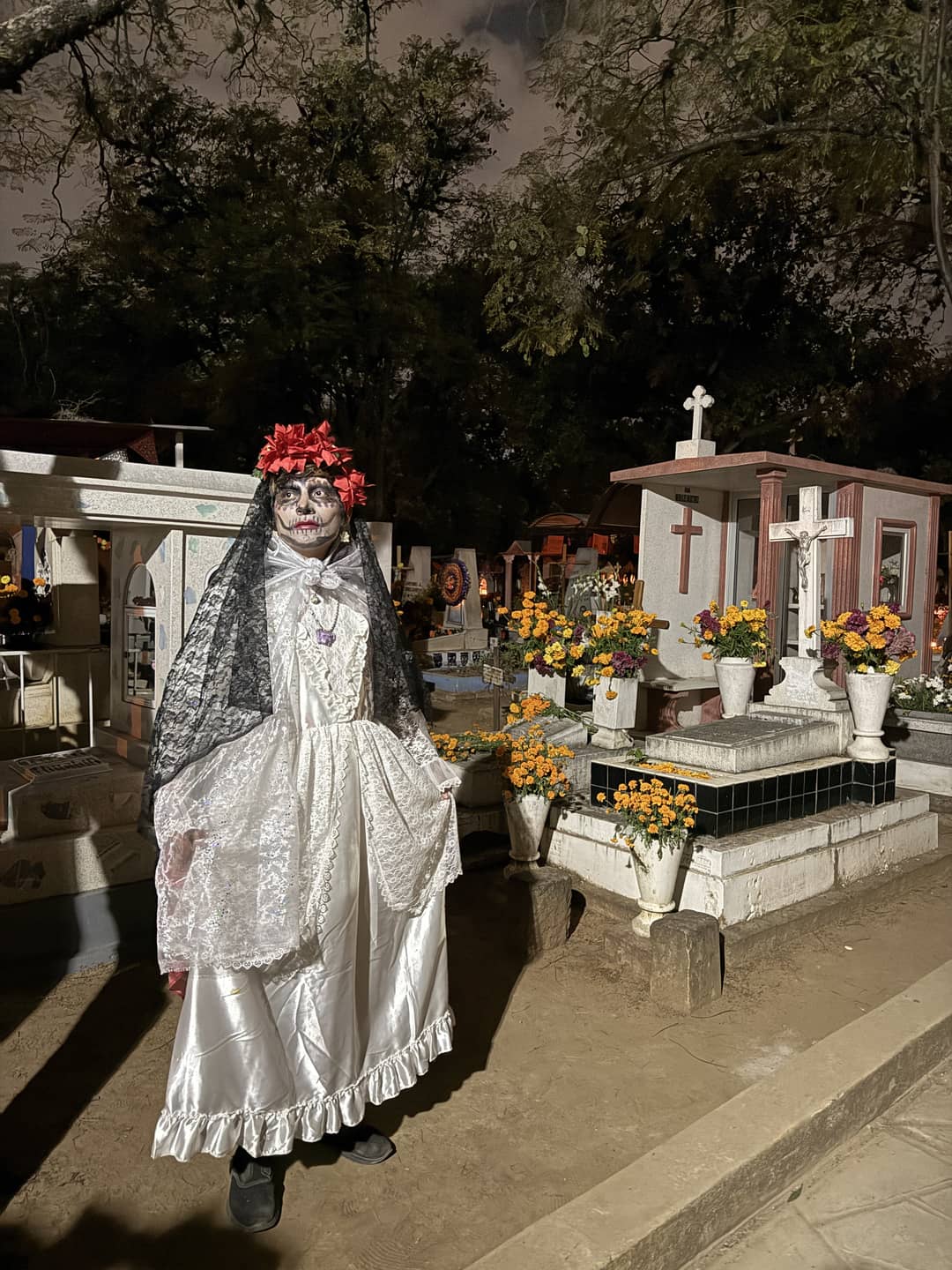 Day of the Dead celebration at a cemetery in Oaxaca with marigold flowers and traditional decorations