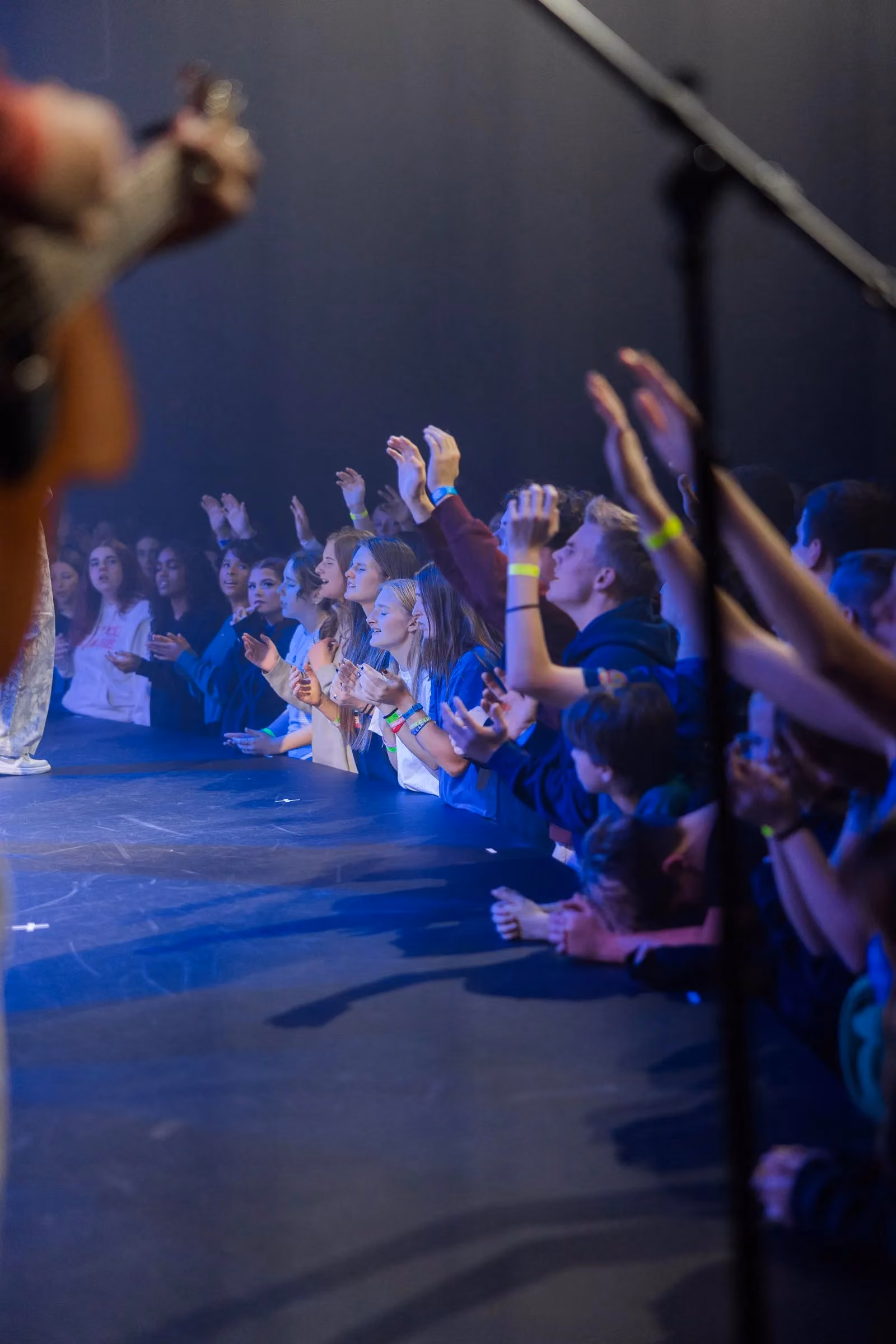 Students gathered at the front of the stage during CrossWalk Youth Conference 2025.