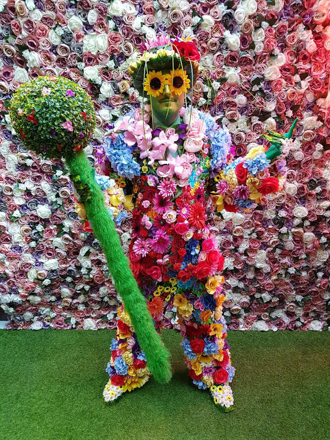 Man wearing a colourful suit of flowers.