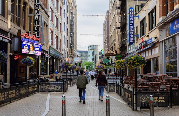 a couple of people that are walking down a street