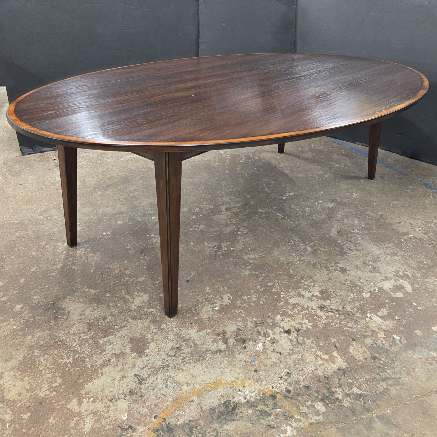 Medium Oak finish, cross banded 96" X 66" oval tapered leg table.