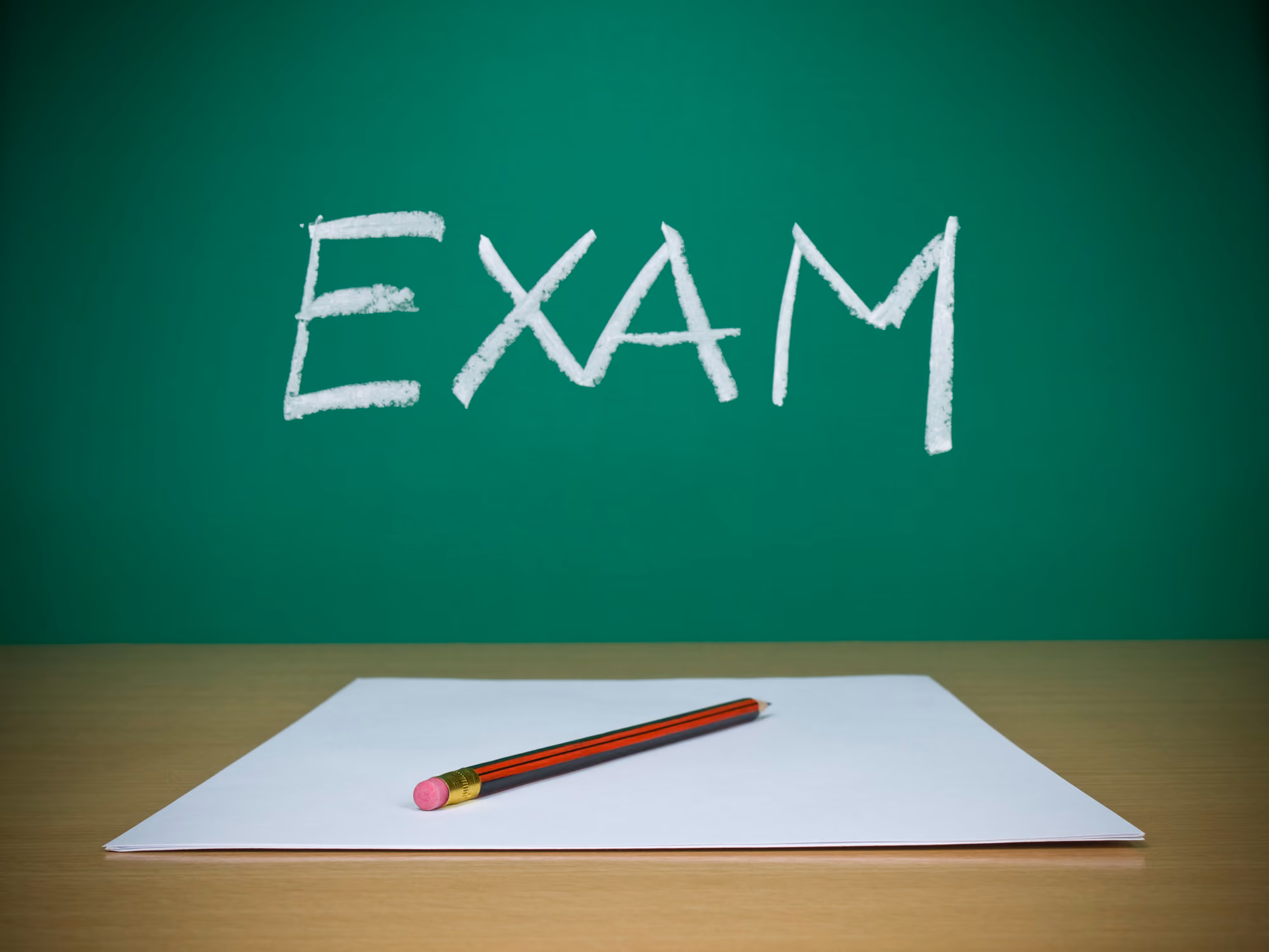 The word exam written on a chalkboard
