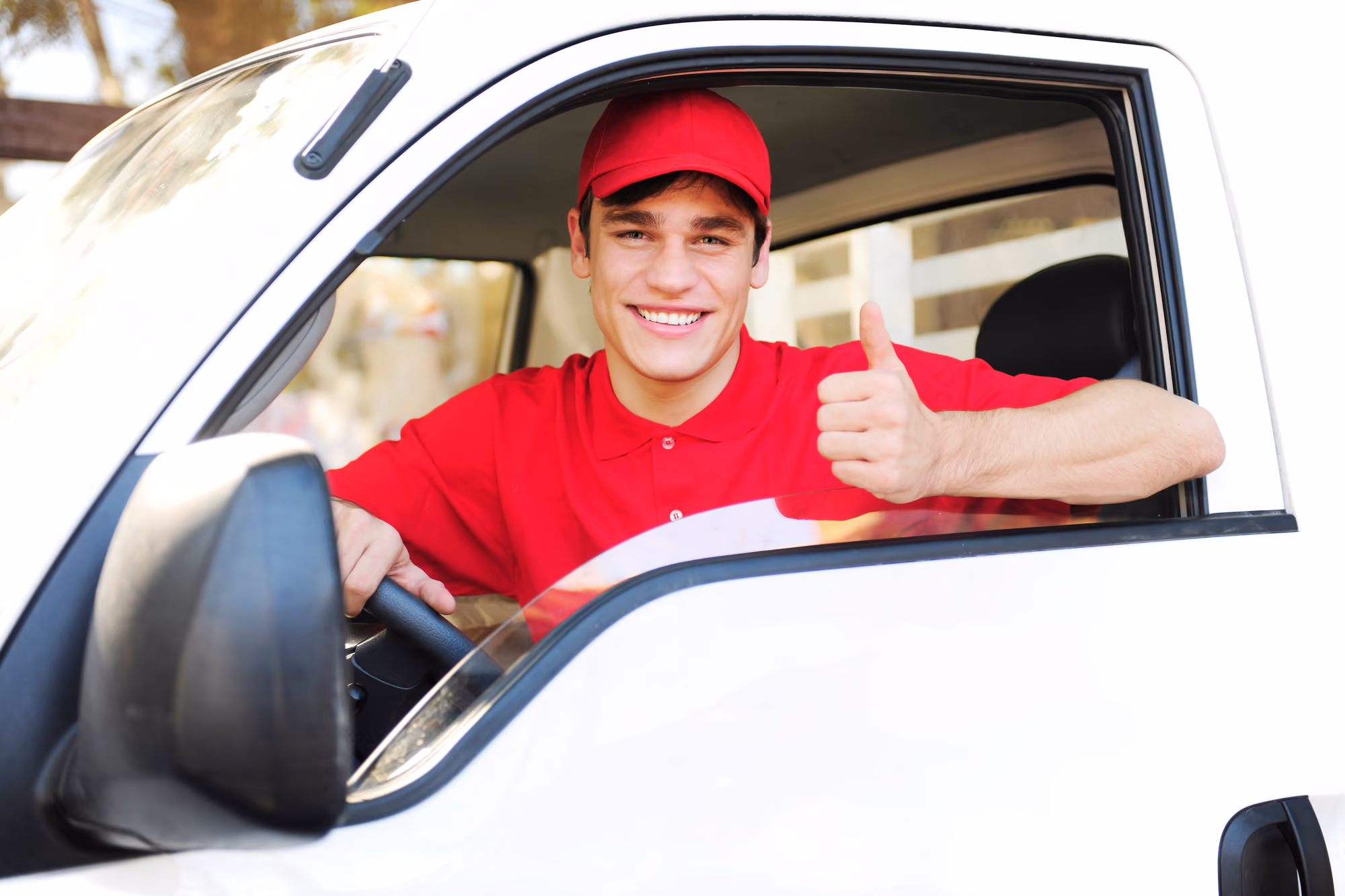 A driver sits in his truck on a delivery