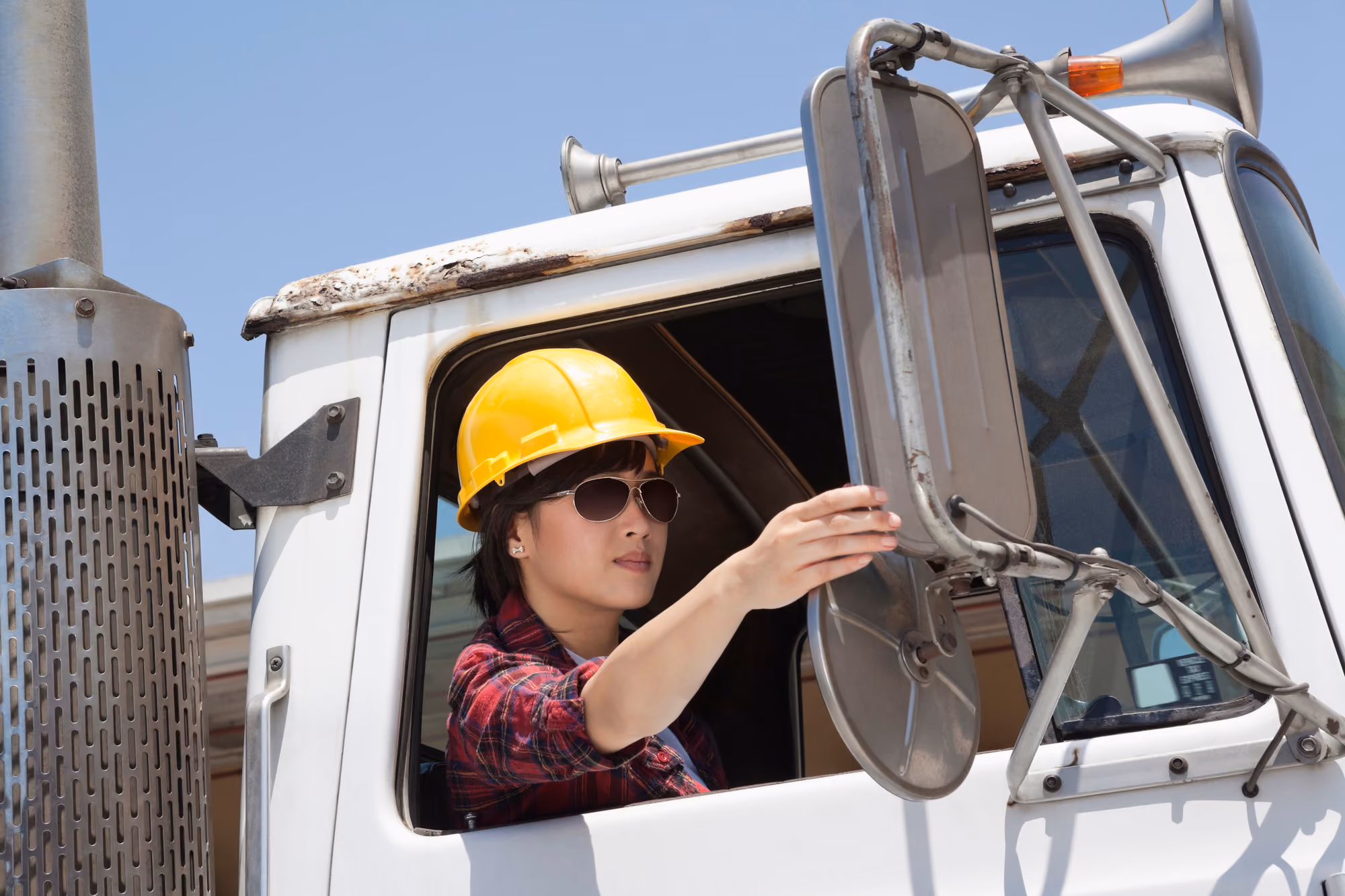 A woman drives a semi truck