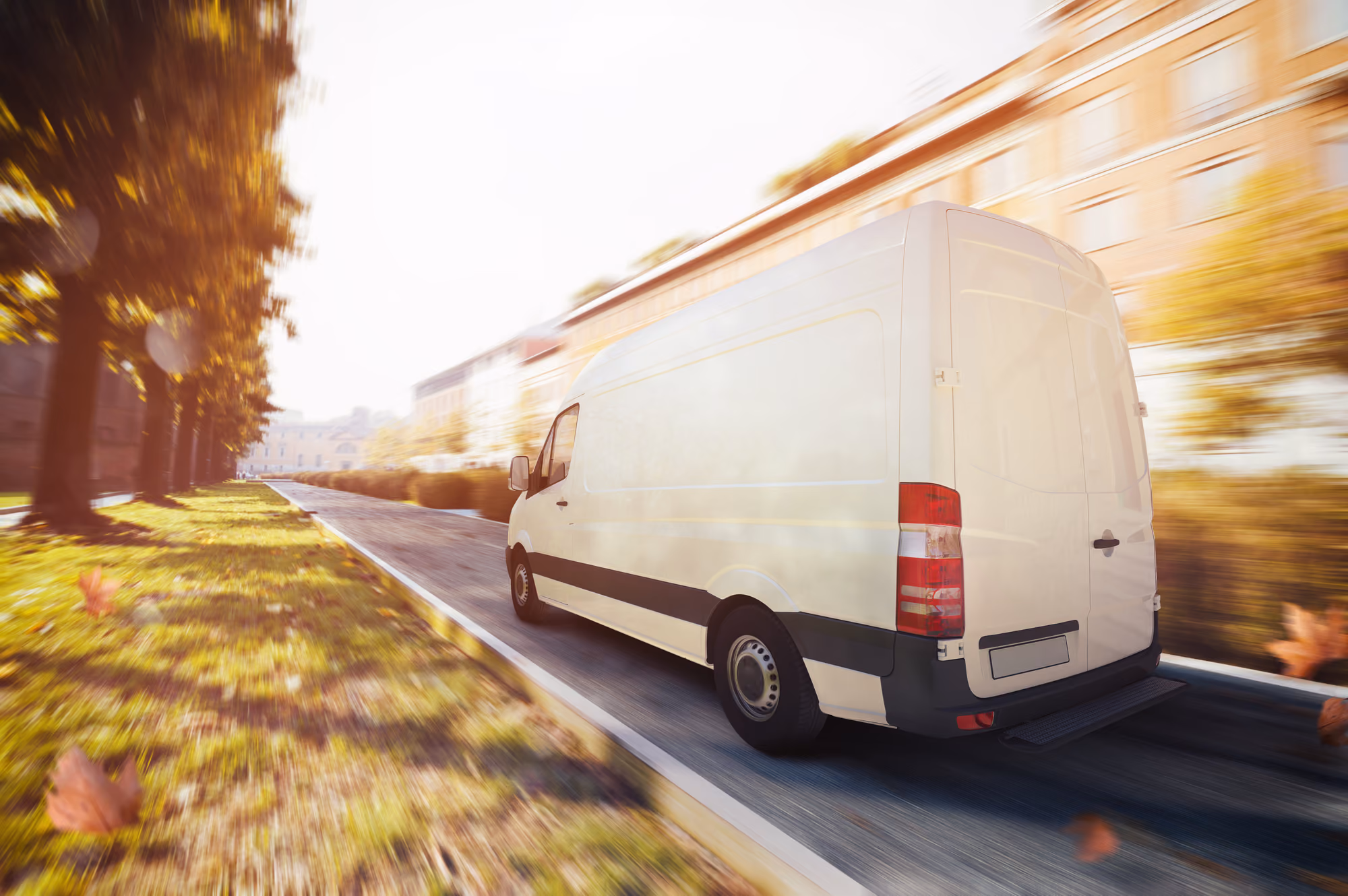 A sprinter van drives fast on a road