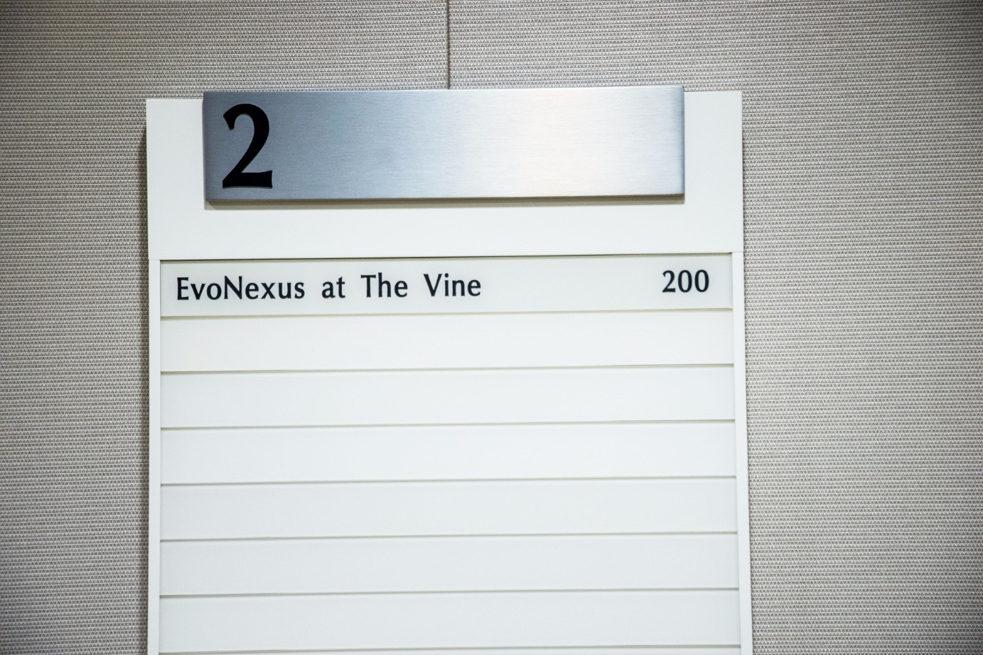 Building directory sign for EvoNexus at The Vine, suite 200 on second floor