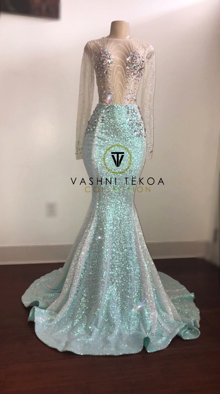 Floor-length sparkly light blue mermaid gown with sheer long sleeves and embellished bodice on a mannequin.