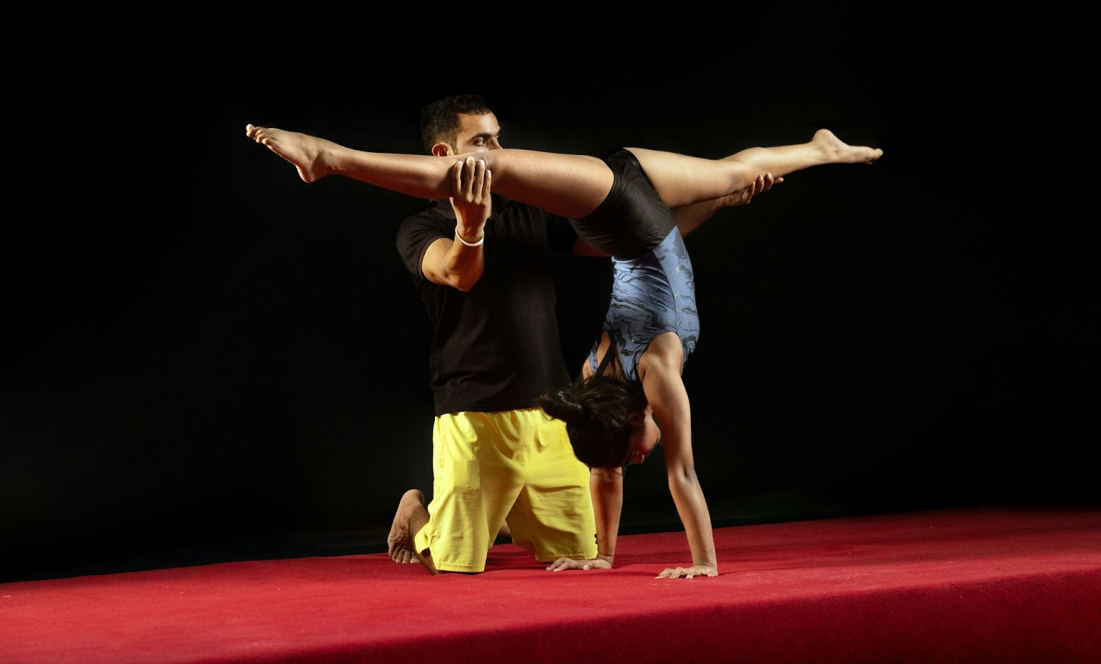 A skilled acro dance instructor in a kids activity center