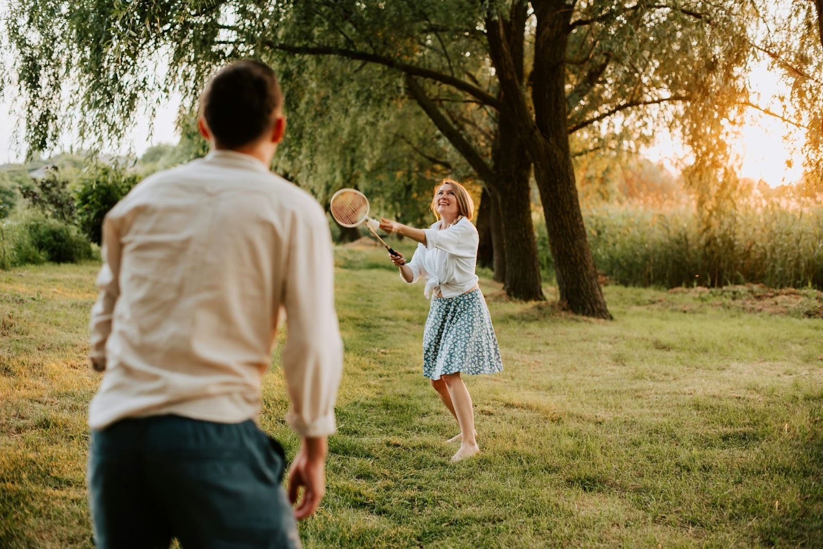 Two people playing badminton