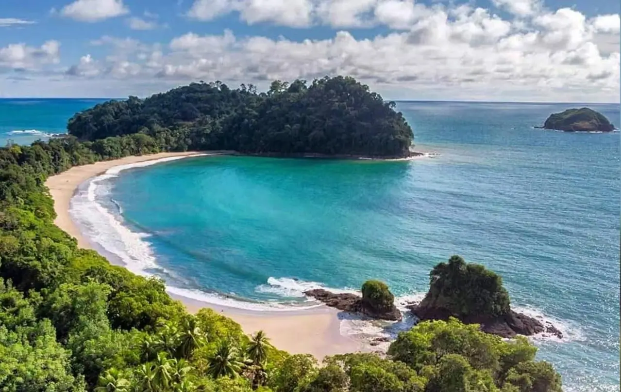 White sand beach and lush tropical rainforest inside Manuel Antonio National Park Costa Rica – Luxury beach vacation package by The Costa Rica Online