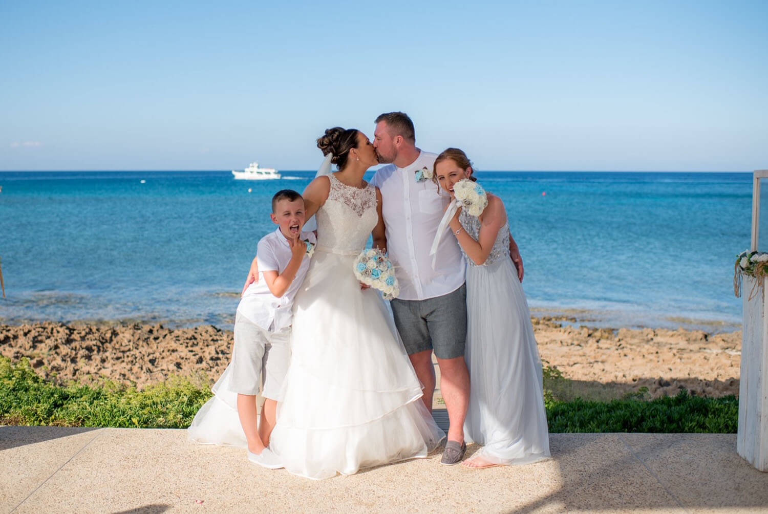 Bride and Groom with their children at the seashore in Cyprus