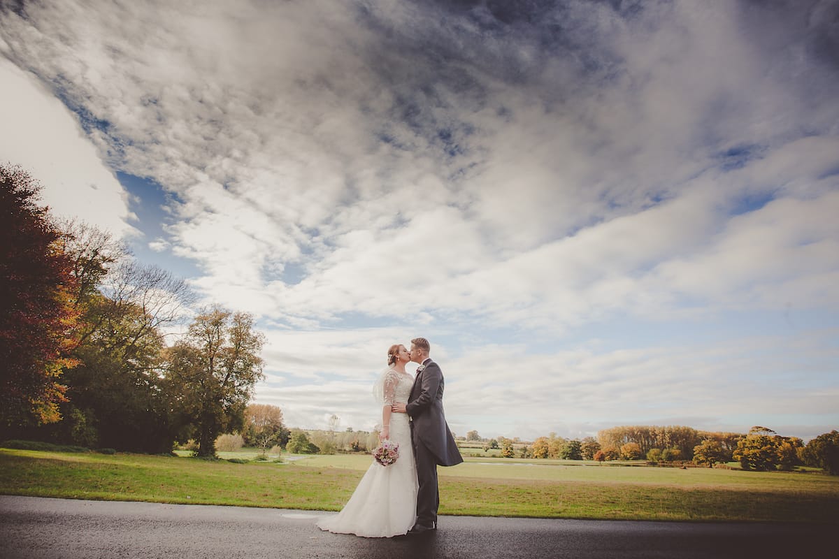 Bride and Groom embraced in the grounds of there reception