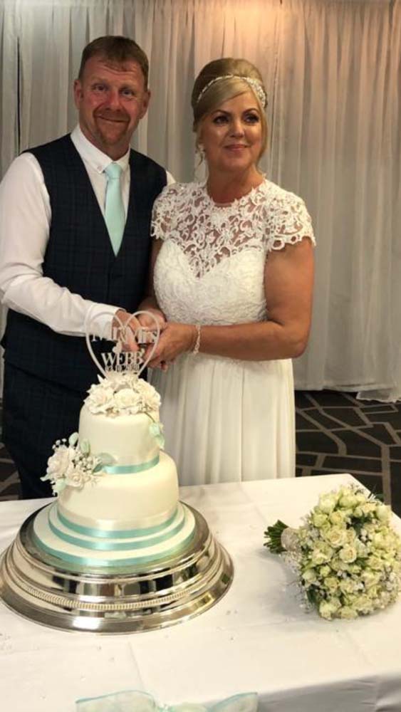 Bride and Groom cutting the cake.