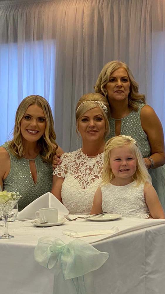 Bride with her two adult bridesmaids and flower girl.