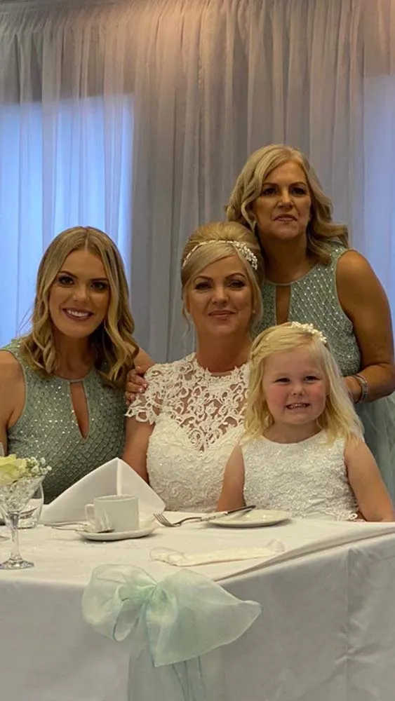 Bride with her two adult bridesmaids and flower girl.